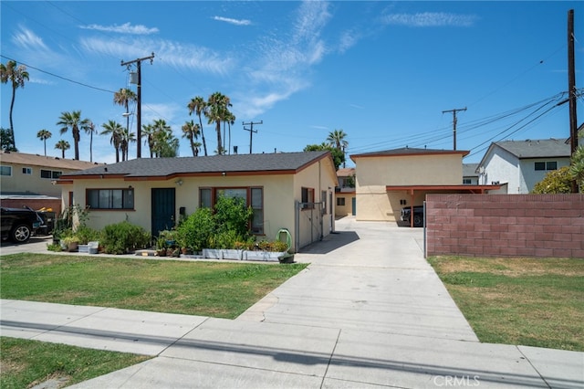 single story home featuring a carport and a front yard