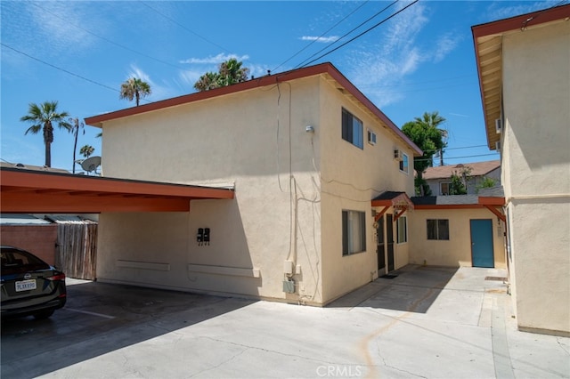 view of side of property featuring a carport