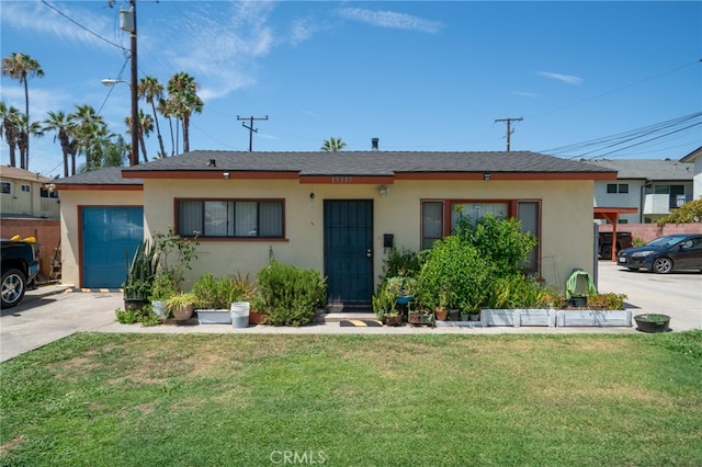 view of front of home with a front yard and a garage