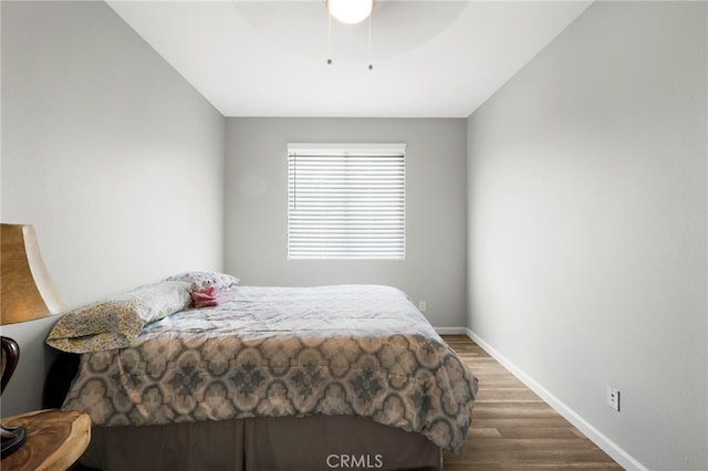 bedroom featuring ceiling fan and dark hardwood / wood-style floors