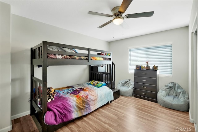 bedroom with wood-type flooring and ceiling fan