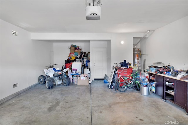 garage featuring a garage door opener and strapped water heater