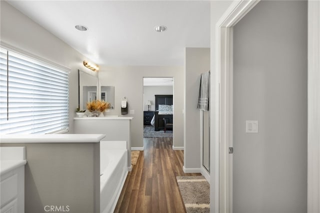 bathroom featuring vanity, hardwood / wood-style floors, and separate shower and tub