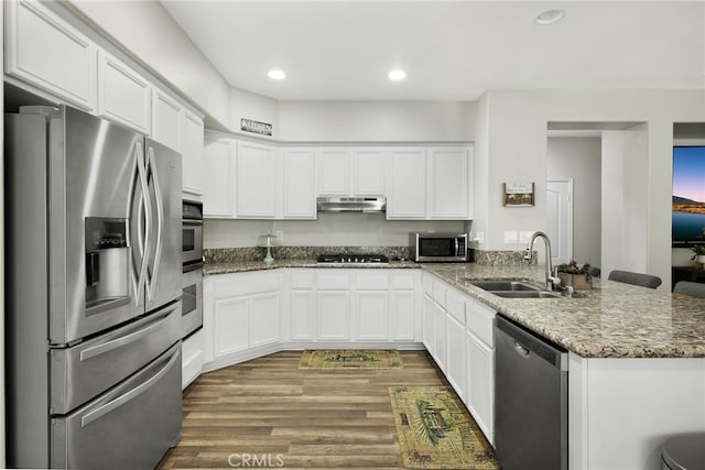 kitchen with light hardwood / wood-style floors, sink, white cabinets, kitchen peninsula, and stainless steel appliances