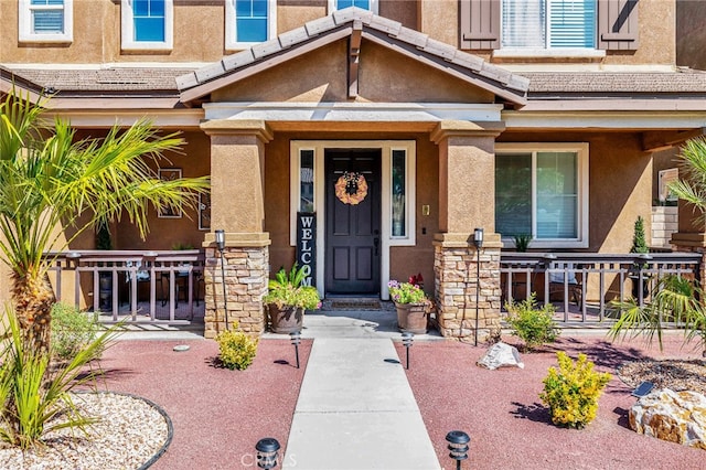 view of exterior entry featuring a porch