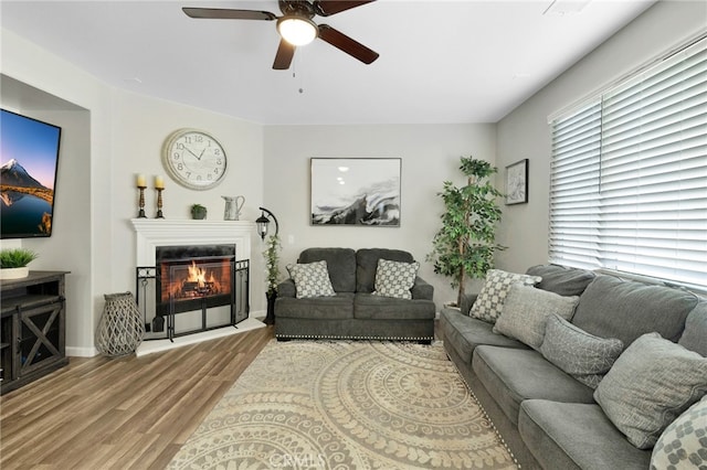 living room featuring light hardwood / wood-style floors and ceiling fan