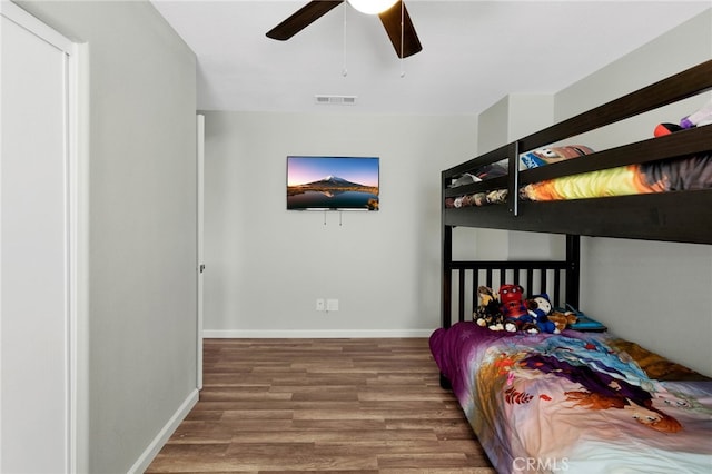 bedroom with ceiling fan and wood-type flooring