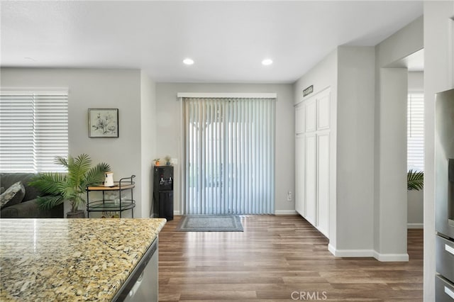 kitchen with light stone countertops and light hardwood / wood-style flooring