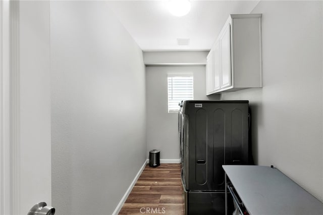 washroom featuring cabinets, dark wood-type flooring, and washer / dryer