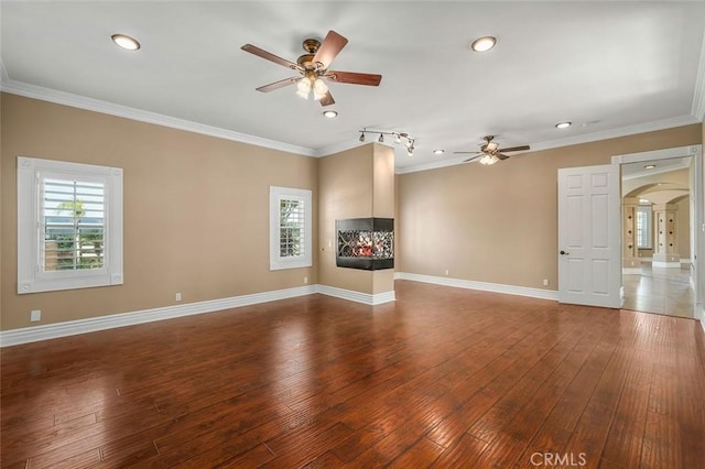 unfurnished living room with ceiling fan, hardwood / wood-style floors, and ornamental molding