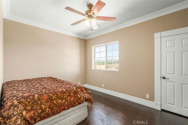 bedroom with ceiling fan, ornamental molding, and dark wood-type flooring