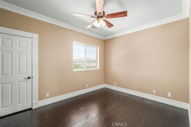 unfurnished room featuring dark hardwood / wood-style floors, ceiling fan, and crown molding