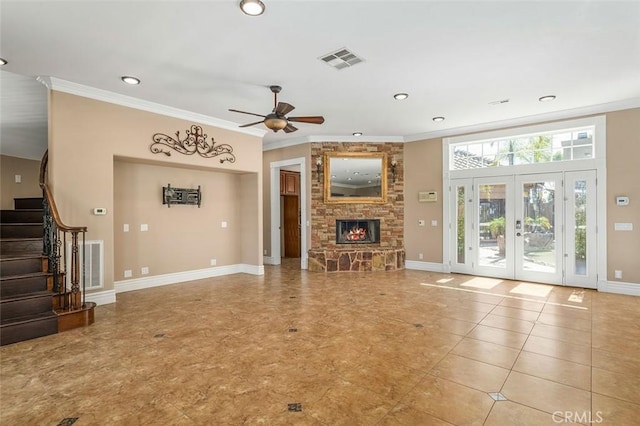 unfurnished living room featuring a stone fireplace, ceiling fan, french doors, and ornamental molding