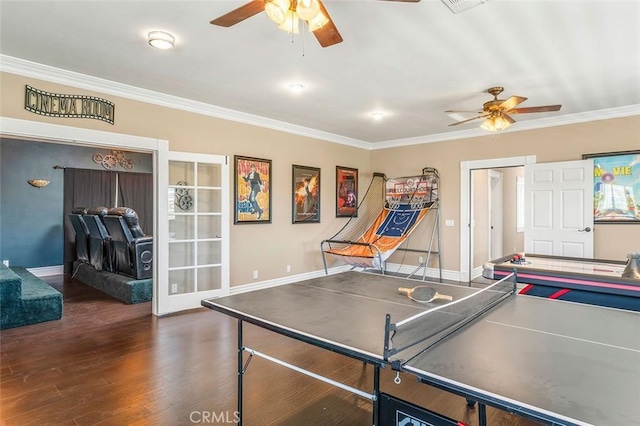 game room featuring crown molding, ceiling fan, and dark wood-type flooring