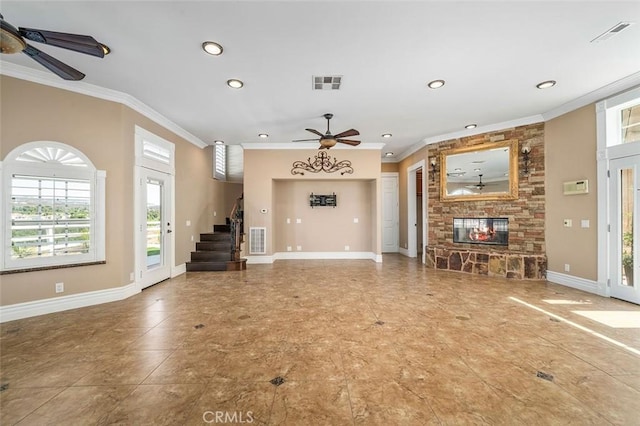 unfurnished living room featuring ceiling fan, ornamental molding, and a fireplace