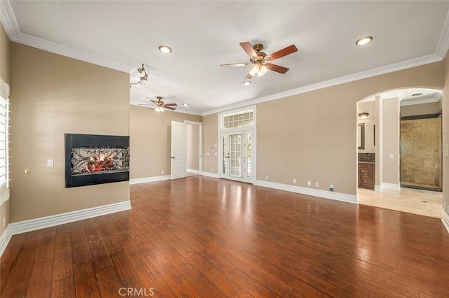 unfurnished living room with crown molding, ceiling fan, and wood-type flooring