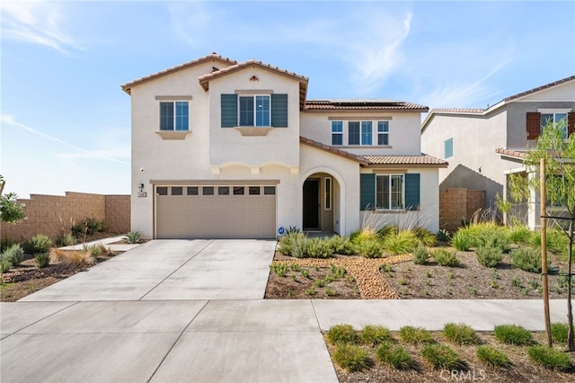 mediterranean / spanish-style house with a garage