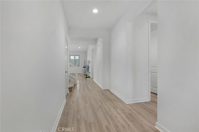 hallway with light hardwood / wood-style floors