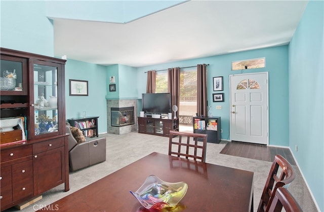 dining space with carpet floors and a fireplace