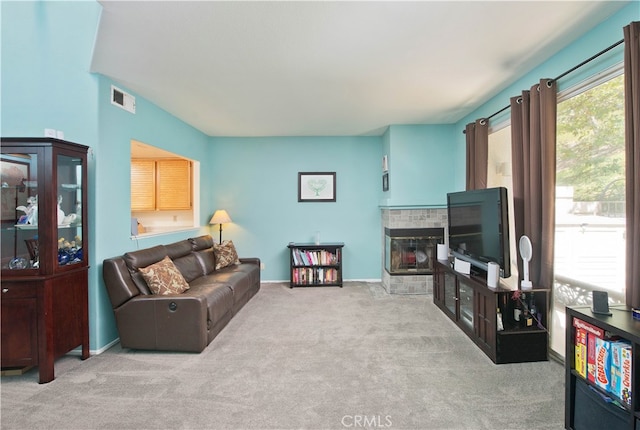 carpeted living room featuring a fireplace