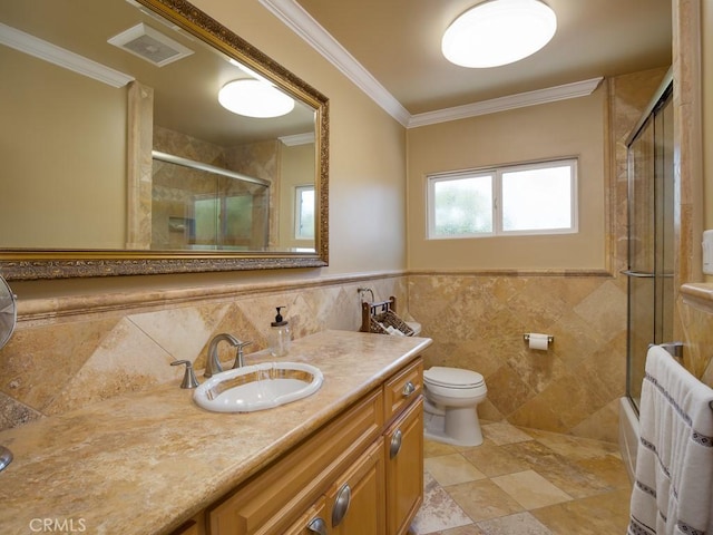 full bathroom with toilet, combined bath / shower with glass door, tile walls, and ornamental molding