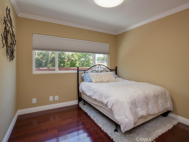 bedroom featuring crown molding and dark wood-type flooring