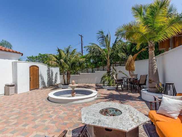 view of patio with a fire pit