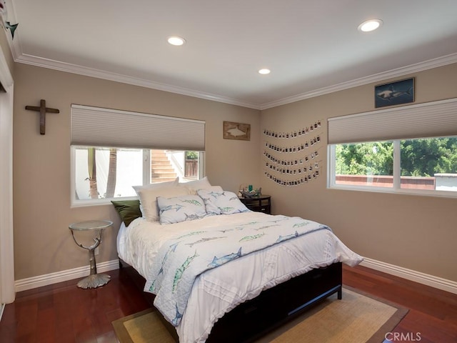 bedroom with dark hardwood / wood-style floors and ornamental molding