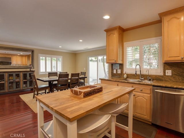 kitchen featuring light brown cabinetry, tasteful backsplash, stainless steel dishwasher, sink, and dark hardwood / wood-style floors