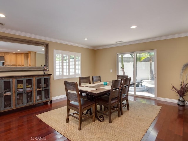 dining area featuring dark hardwood / wood-style floors and ornamental molding