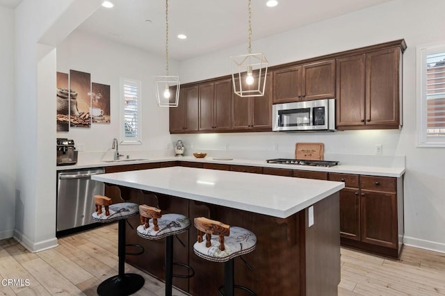 kitchen featuring sink, plenty of natural light, light hardwood / wood-style floors, and appliances with stainless steel finishes