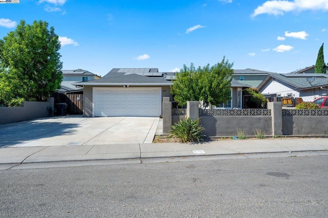 view of front of home featuring solar panels and a garage