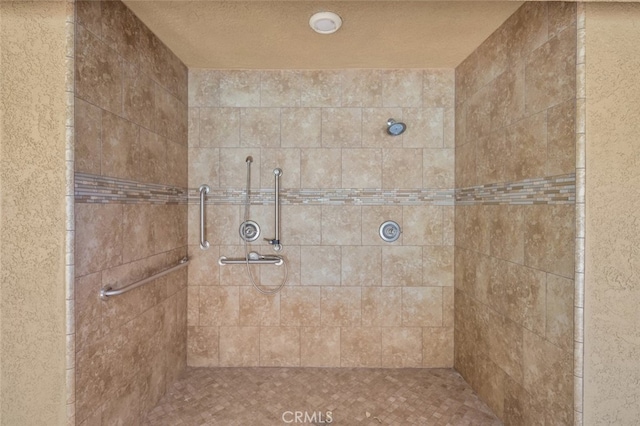 bathroom featuring a textured ceiling and an enclosed shower