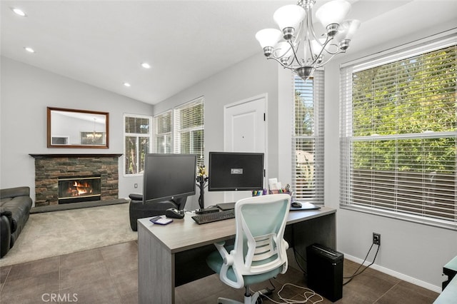 carpeted office featuring a notable chandelier, a wealth of natural light, lofted ceiling, and a fireplace