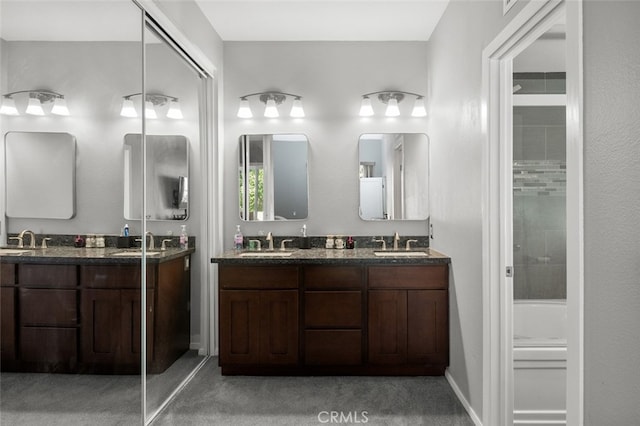 bathroom featuring walk in shower and vanity