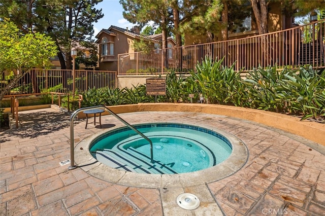 view of swimming pool with a patio area and a hot tub