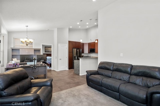 living room with a notable chandelier, high vaulted ceiling, and tile patterned floors