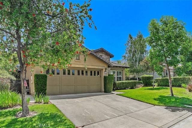 view of front of house featuring a garage and a front lawn