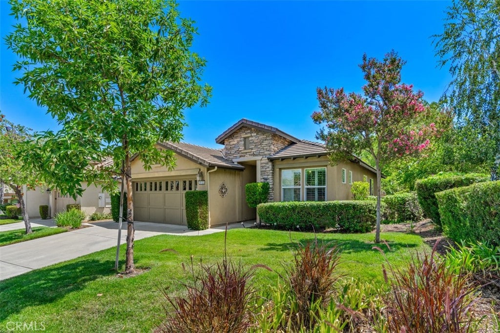 single story home with a garage and a front yard