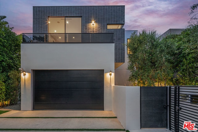 contemporary home featuring a balcony and a garage