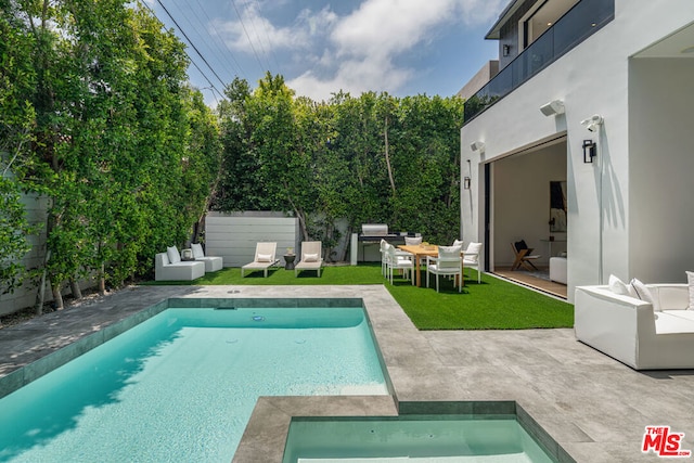 view of swimming pool featuring a lawn and a patio