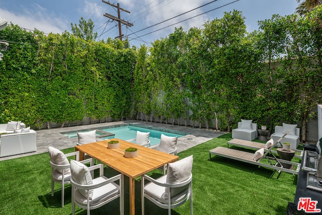 view of pool featuring a lawn and a patio area