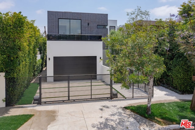 contemporary home with a garage and a balcony