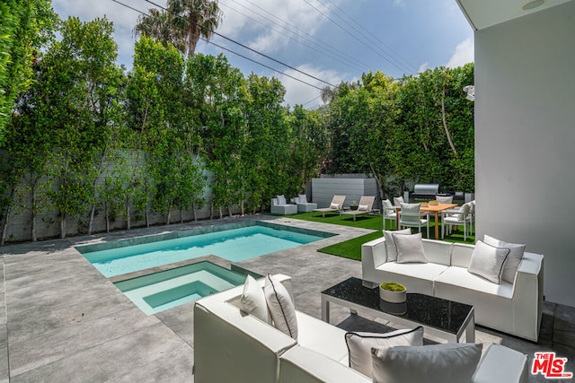 view of pool featuring an in ground hot tub, an outdoor hangout area, and a patio area