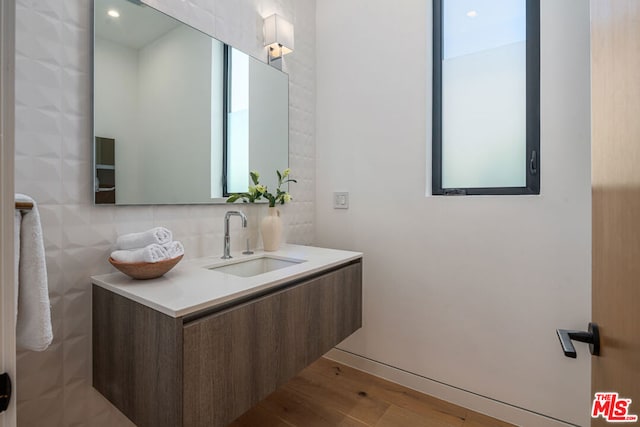 bathroom featuring vanity, wood-type flooring, and a wealth of natural light