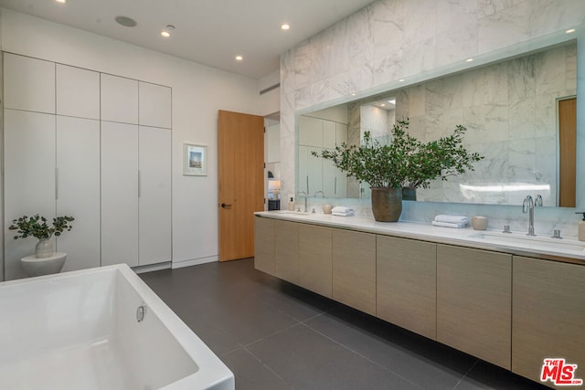 bathroom with vanity, a tub to relax in, and tile patterned floors