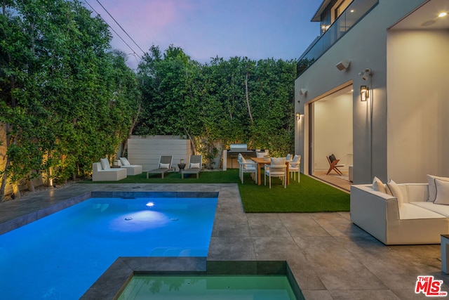 pool at dusk featuring an outdoor living space, an in ground hot tub, and a patio