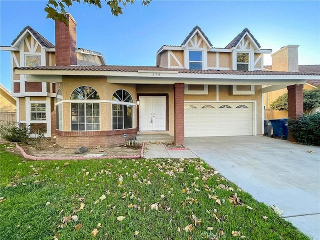 view of front of property with brick siding, a chimney, stucco siding, a garage, and driveway