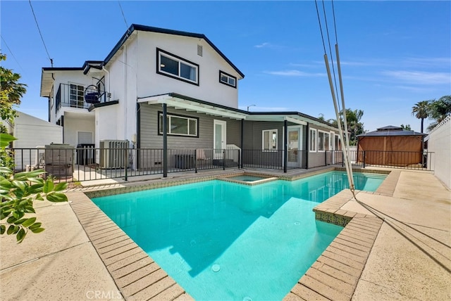 view of pool with central AC unit and a patio area