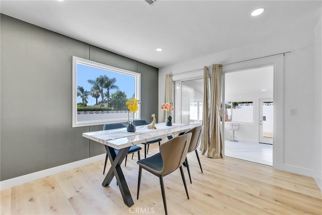 dining space with light wood-type flooring